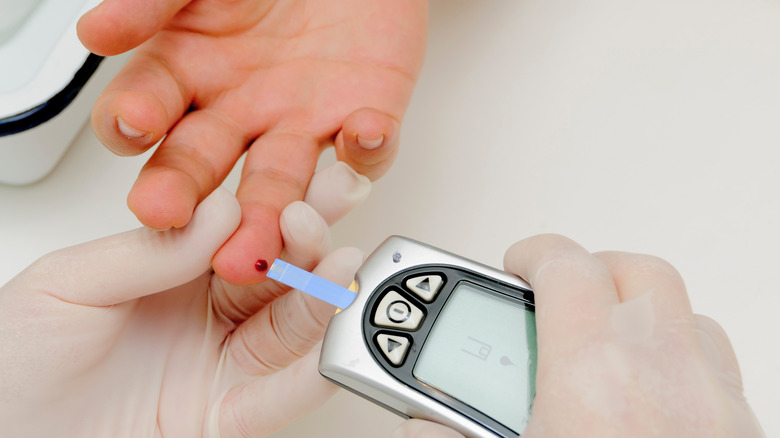 Person having their blood glucose level tested