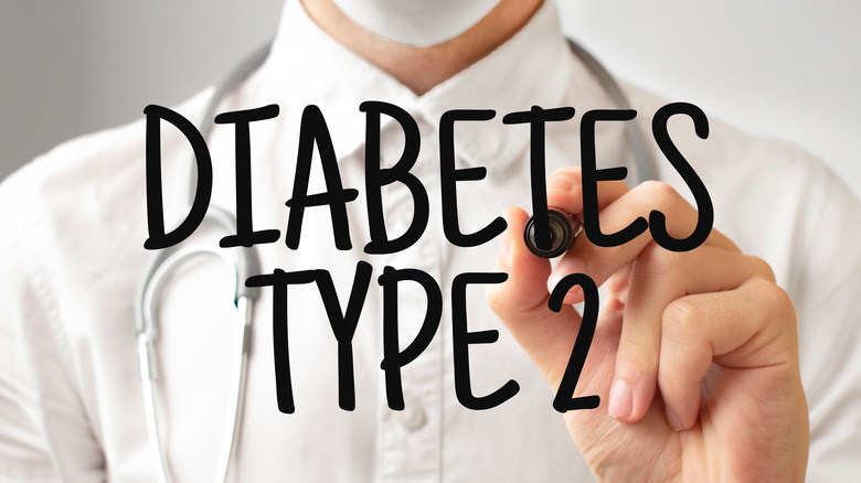 Medical professional writing "Diabetes Type 2"