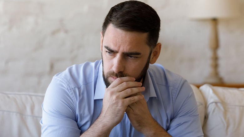 man sitting with worry