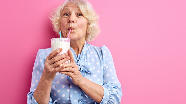 older woman drinking milk