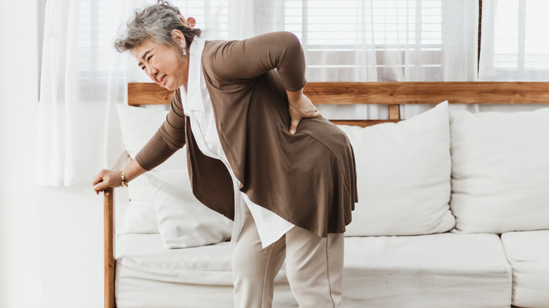 aged woman feeling back pain