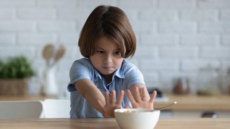 Child pushing away a bowl of food