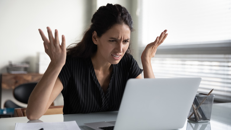 Woman angrily looking at computer