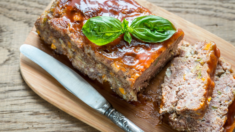 A sliced meatloaf with barbecue sauce