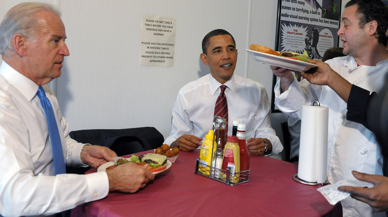 Joe Biden being served a cheeseburger