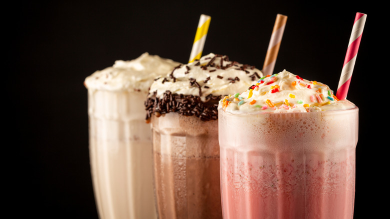 trio of milkshakes with straws