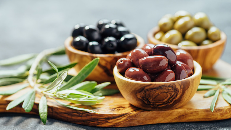 wooden bowls of different olives