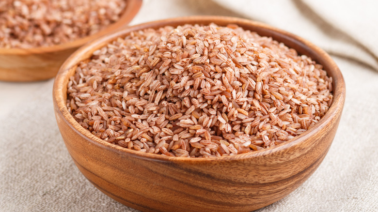 rice grains and wooden spoon