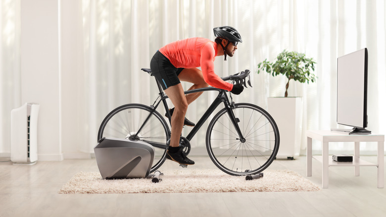 man riding stationary bike