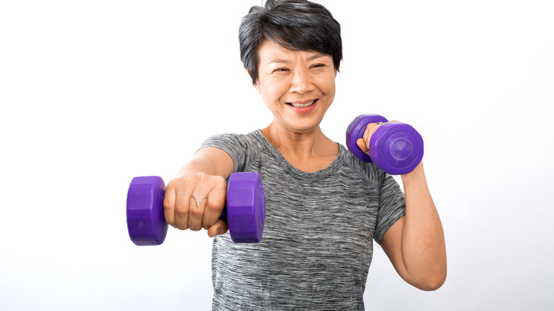 woman using dumbbells