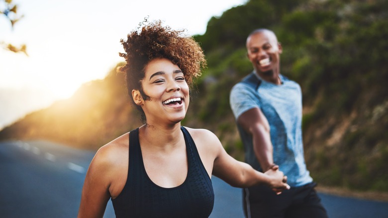 Couple happily running outdoors