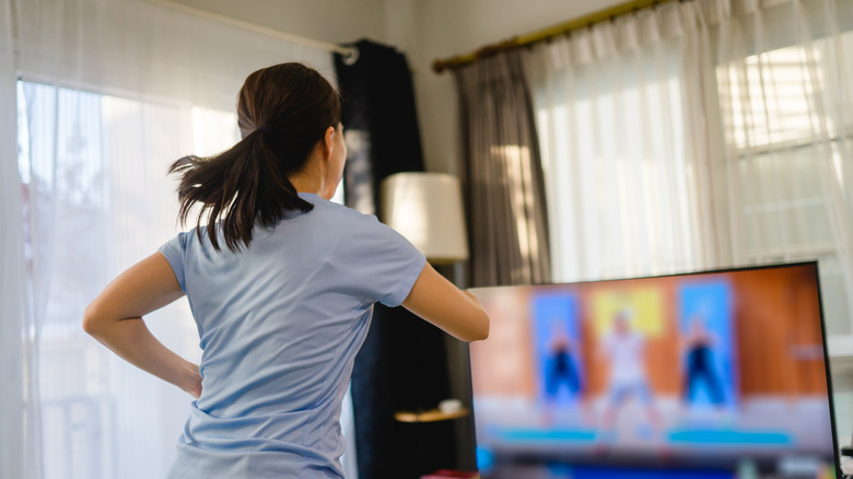 Woman excercising with TV