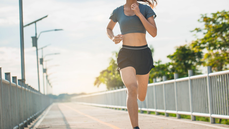 Woman running along road