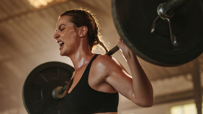 Woman with heavy weight on back