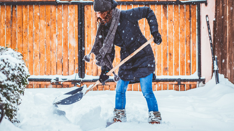 Woman shoveling snow during winter