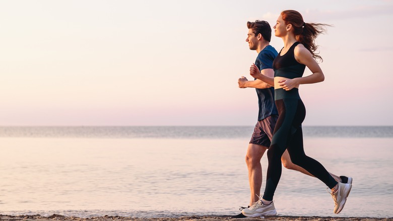 Couple jogging on beach