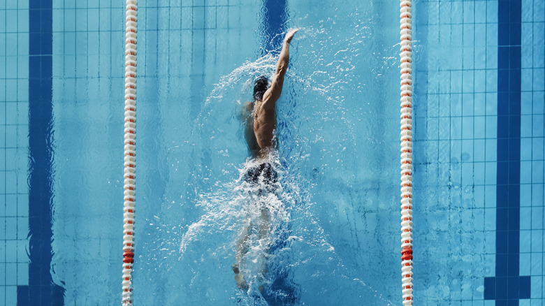 Athletic person swimming laps in pool