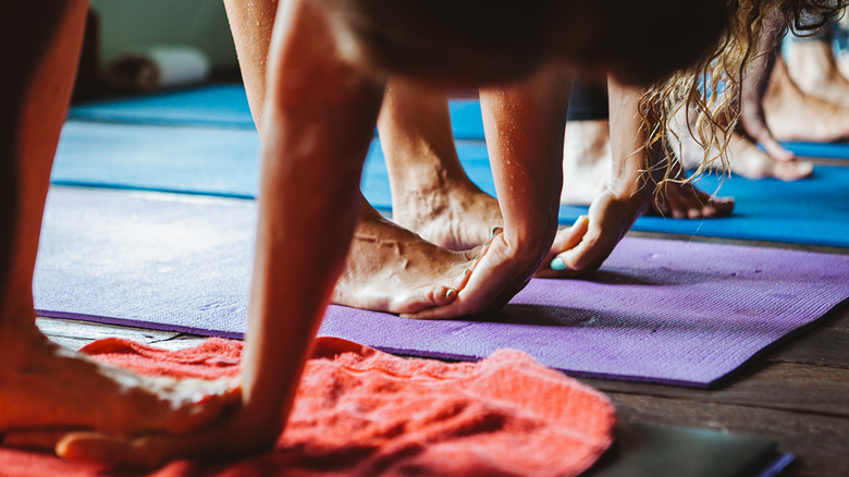 woman doing hand under foot pose