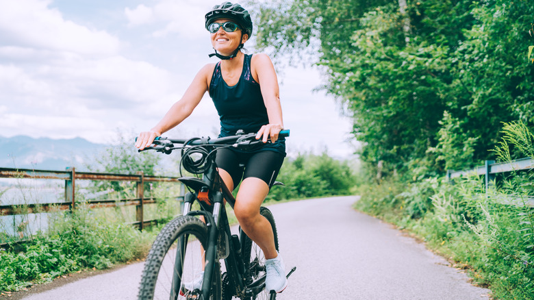 Person smiling on bicycle outside