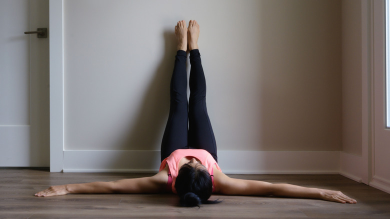 woman doing legs-up-the-wall-pose