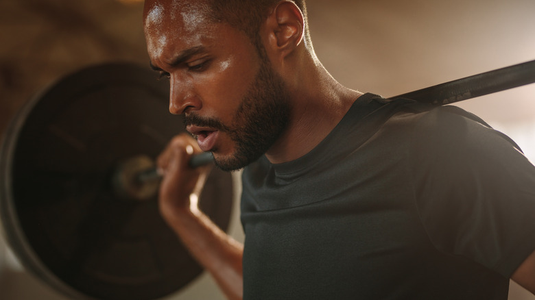 man lifting weights