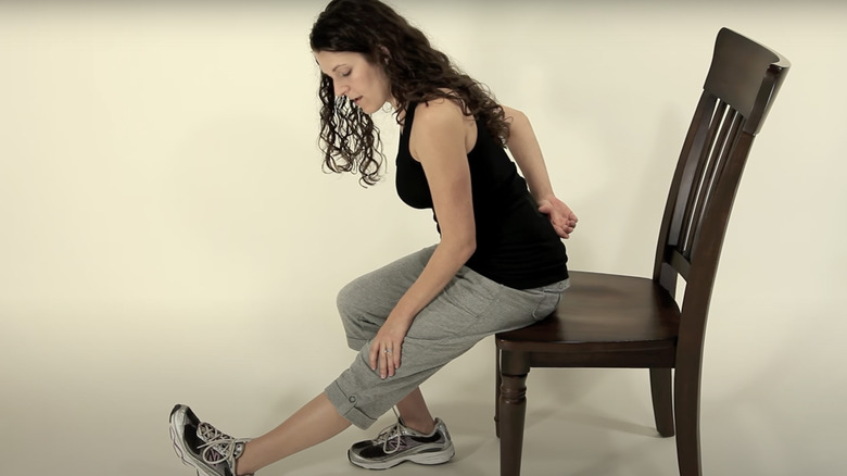 woman doing seated chair stretch