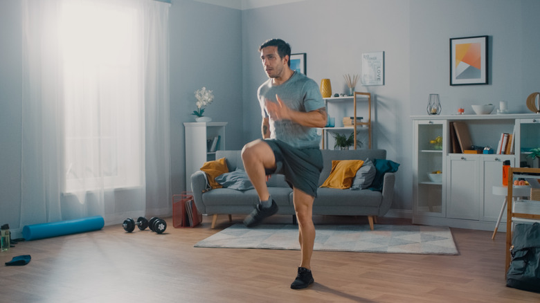 man running in place at home