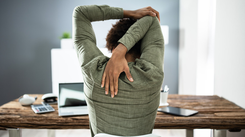 Black woman doing triceps stretches