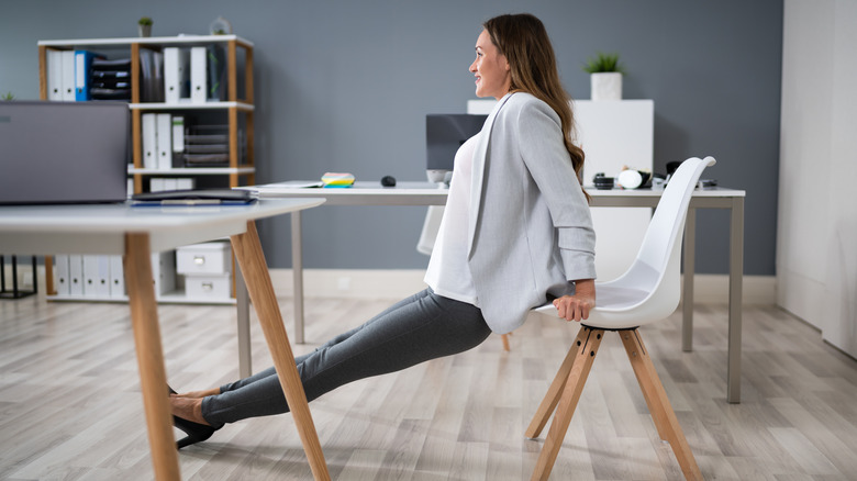  woman doing triceps dips on her office chair