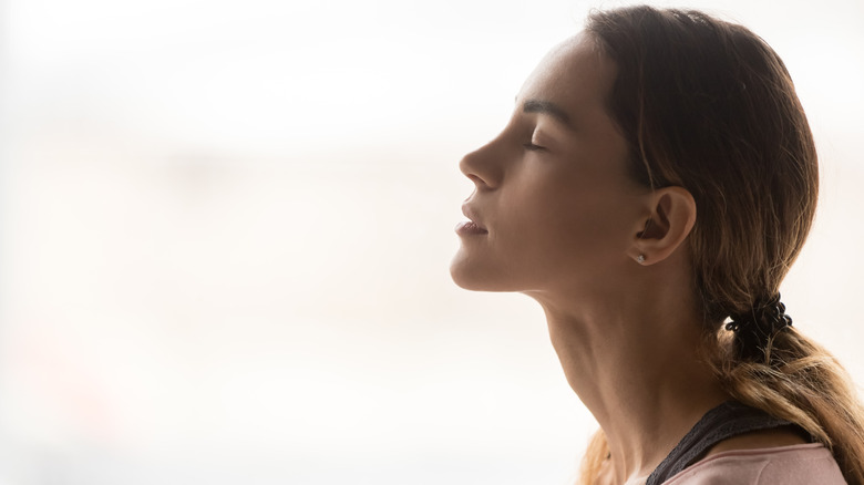 woman taking deep breath