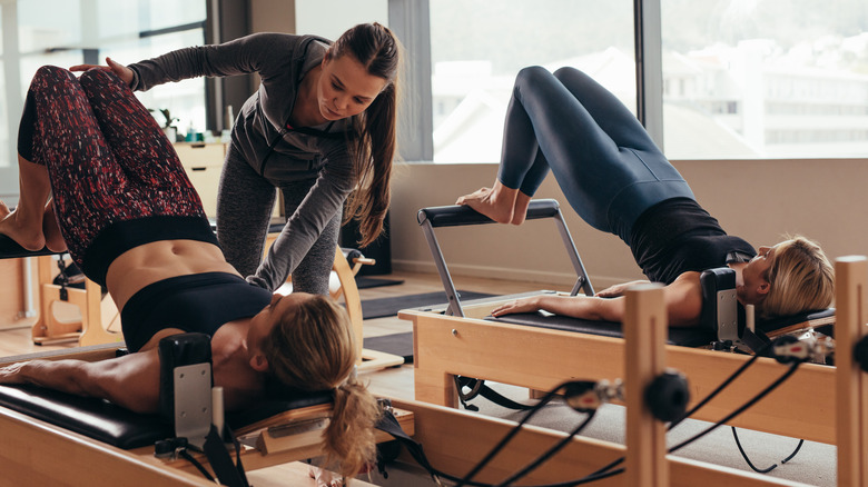 women on pilates equipment