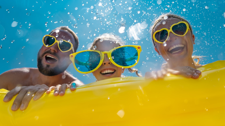 happy family swimming in pool