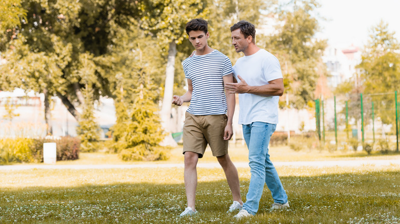 two men walking outside