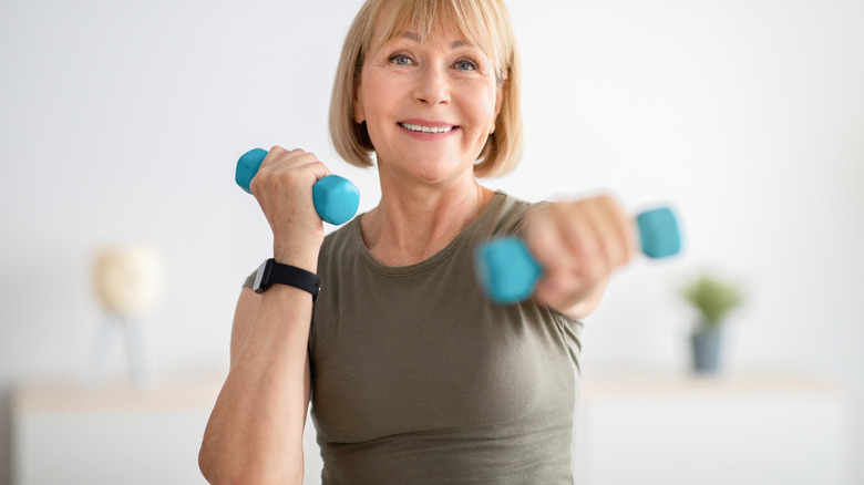 Mature woman using hand weights