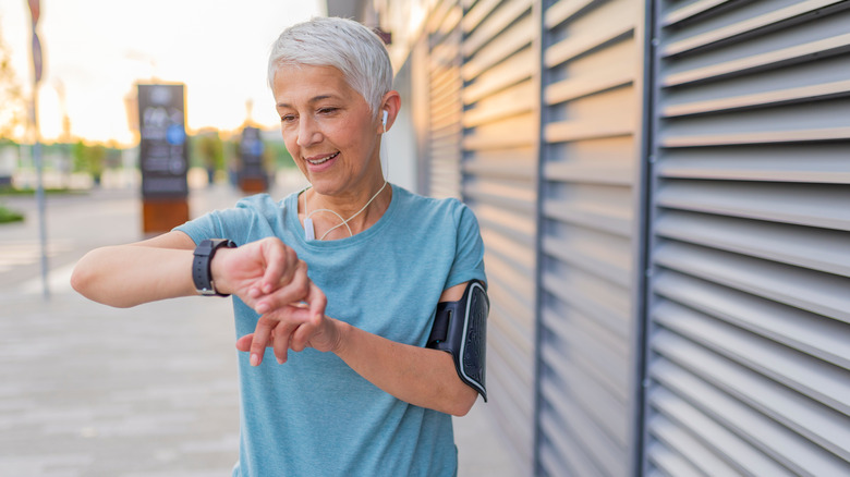 woman checking exercise watch