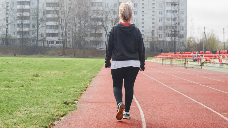 woman walking on track