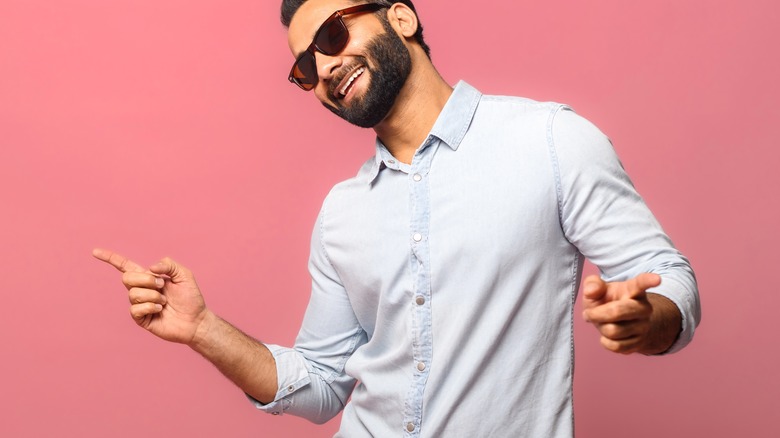 man dancing with pink background