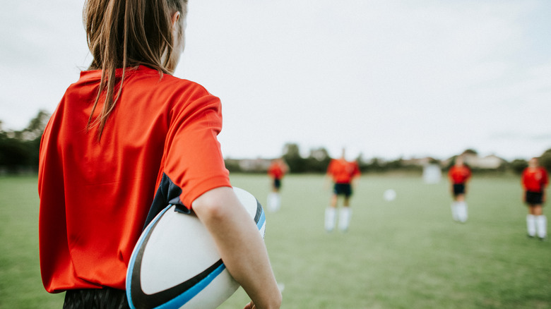 female rugby player holding ball