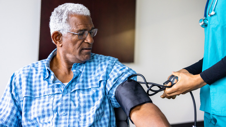 Older man having his blood pressure checked