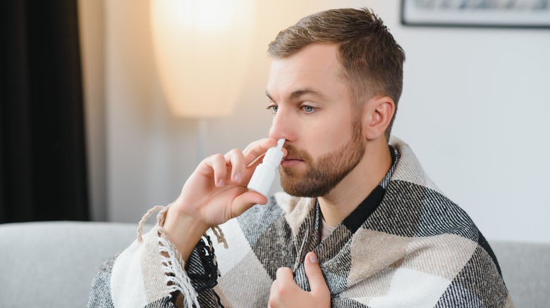 Man taking nasal spray