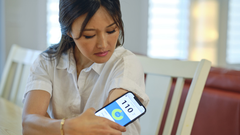 Woman checking her blood glucose level