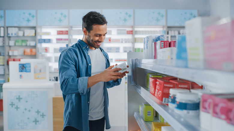 Man looking at supplements in store