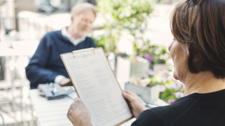 woman looking at a menu