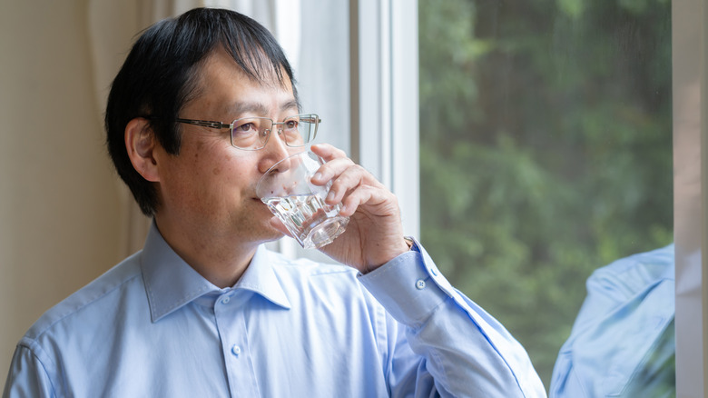 Middle-aged man drinking water