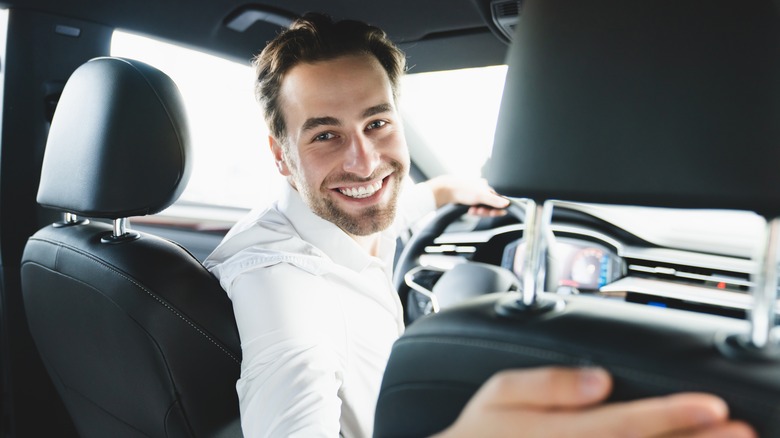 Man in driver's seat smiling