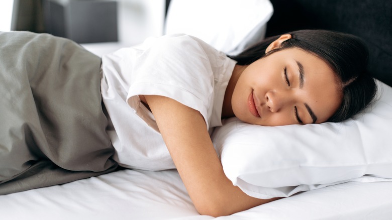 Woman sleeping and hugging pillow