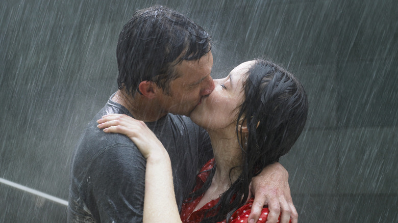 Man and women kissing in the rain