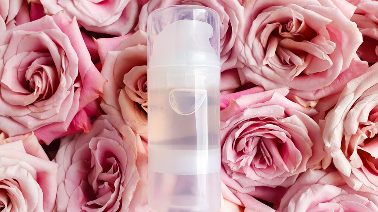 Bottle of lubricant set on roses