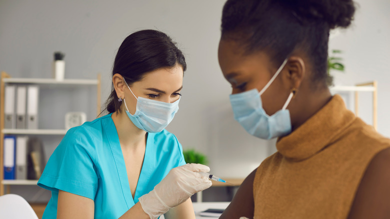 black woman receiving a vaccine