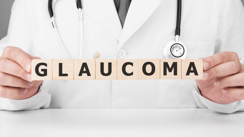 Doctor holding wooden blocks spelling glaucoma